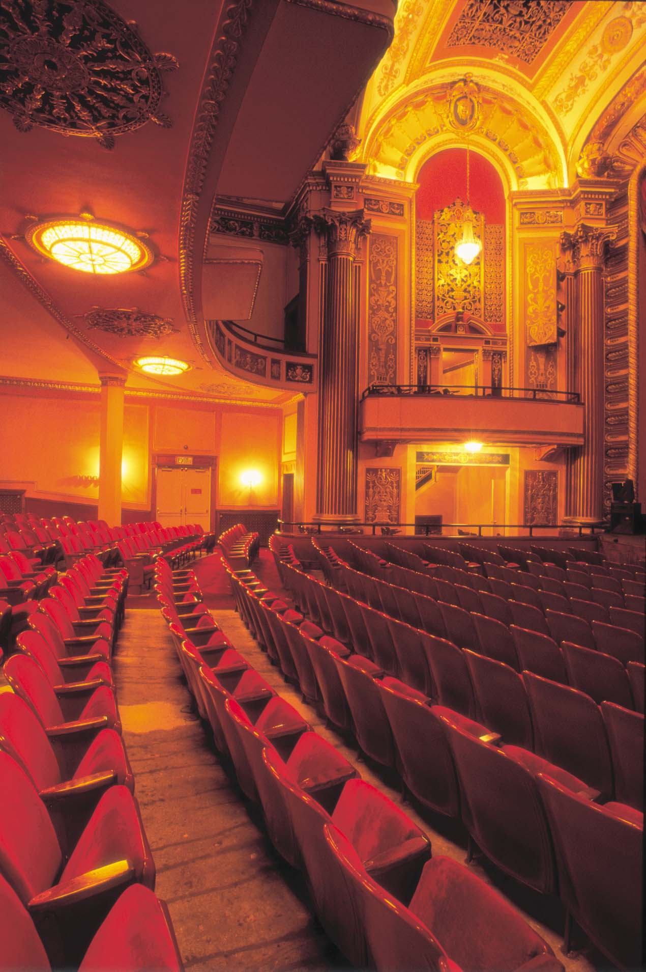Rows of red theatre chairs curve into the gorgeous, golden walls and ceilings of The Strand Theatre.